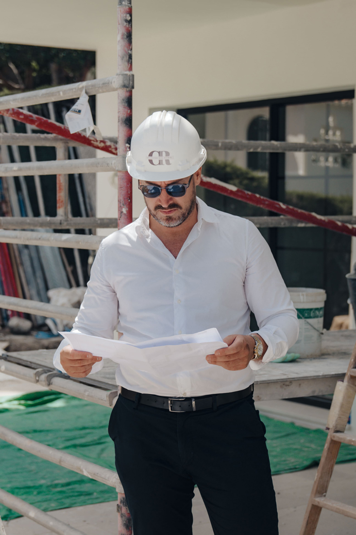 Architect on a construction site looking at a plan